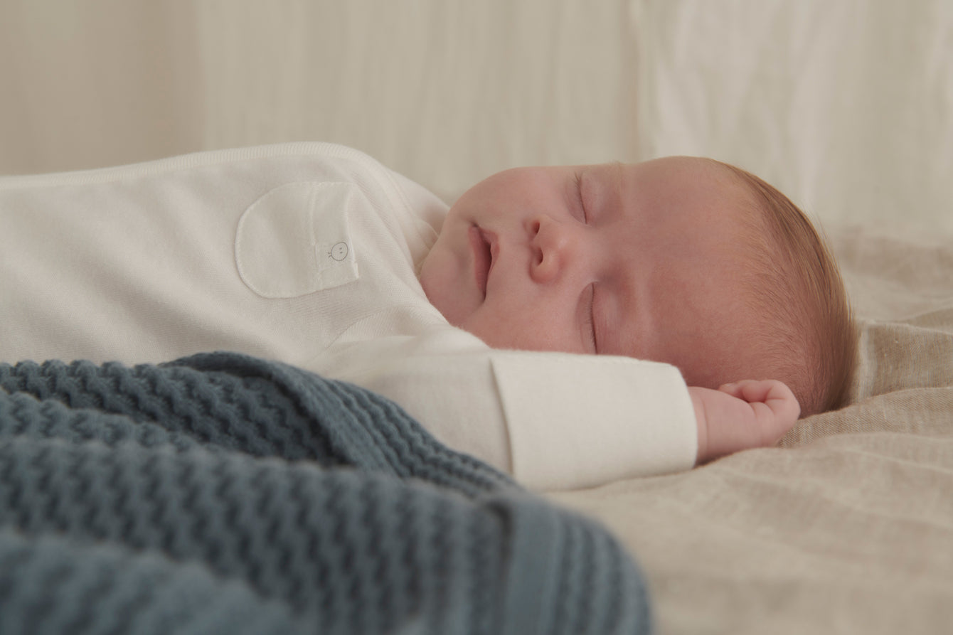baby sleeping in MORI clever zip sleepsuit