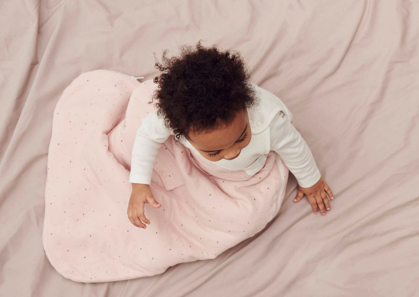 beautiful baby in MORI clever sleeping bag and log sleeve bodysuit onesie