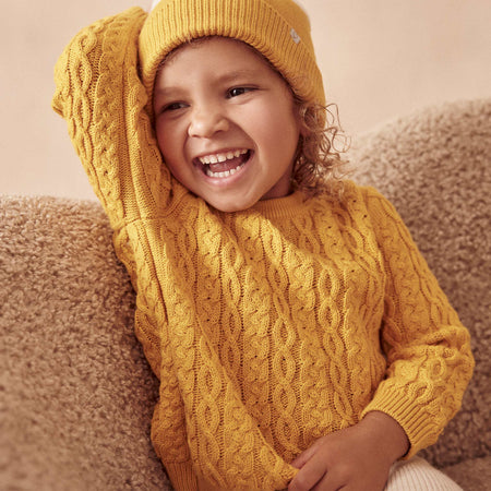 Beautiful girl wearing MORI's Yellow Cable Knit Jumper & Knitted Colourblock Beanie Hat