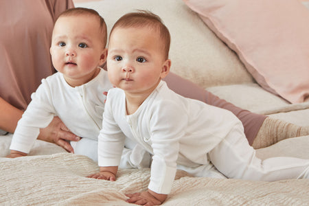 happy baby girl and boy in MORI's clever zip sleepsuits 