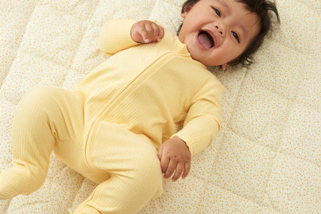 happy baby girl and boy in MORI's clever zip sleepsuits