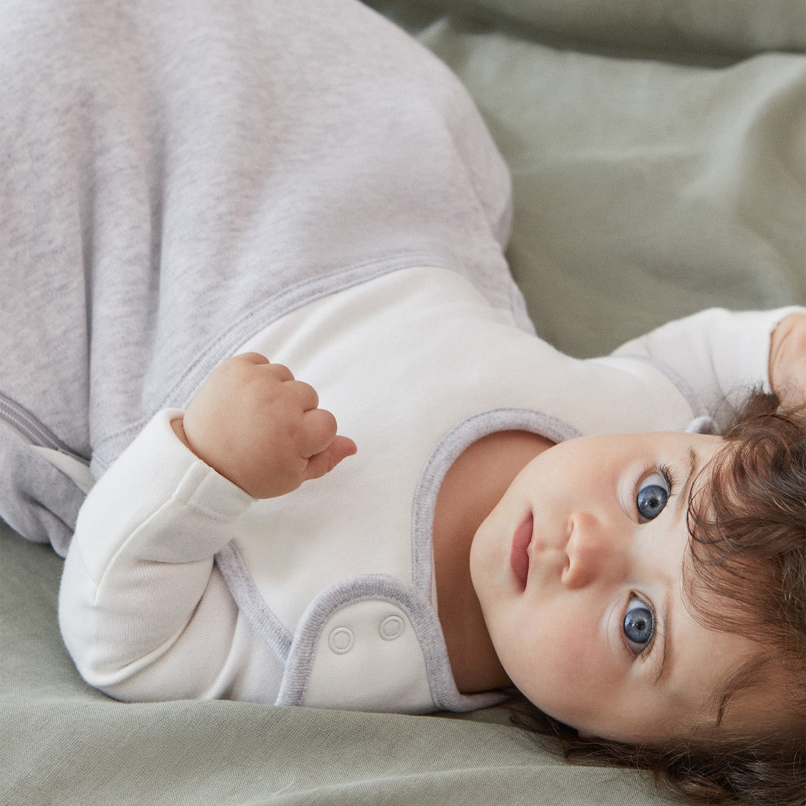 baby in grey sleeping bag