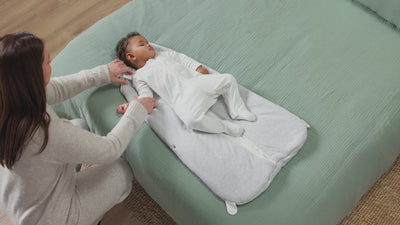 mother zipping baby in MORI front opening sleeping bag